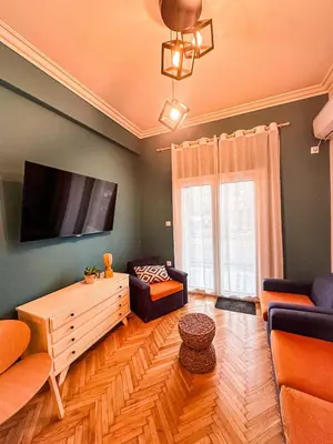 a living room with a couch and a tv at The North Nest in Athens