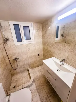 a bathroom with a sink and a toilet and a mirror at The North Nest in Athens