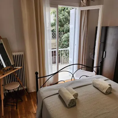 a bedroom with a bed with two towels on it at Athens Nest one in Athens