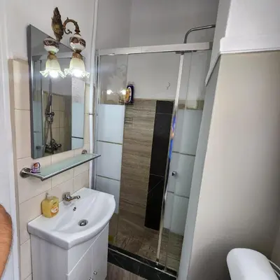 a small bathroom with a sink and a shower at Athens Nest one in Athens