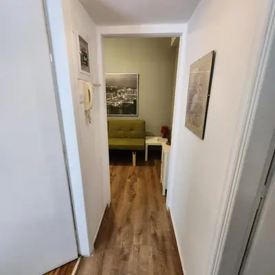 a hallway with a green couch in a room at Athens Nest one in Athens