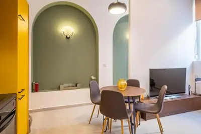 a dining room with a table and chairs at Pasalimani Seabreeze Apartment in Piraeus