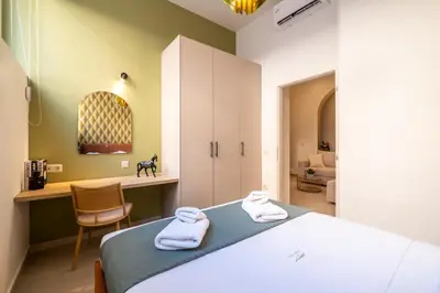 a bedroom with a bed with two towels on it at Pasalimani Seaside Apartment in Piraeus