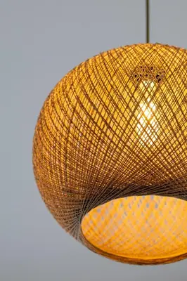 a yellow straw hat hanging from a ceiling at Pasalimani Seaside Apartment in Piraeus