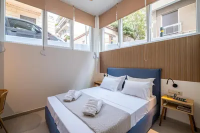 a bedroom with a bed with two towels on it at Pasalimani Seaside Apartment in Piraeus