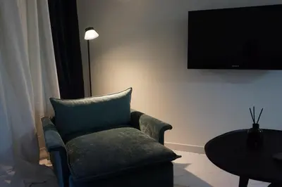 a living room with a couch and a table and a television at Athens City apartment in Athens