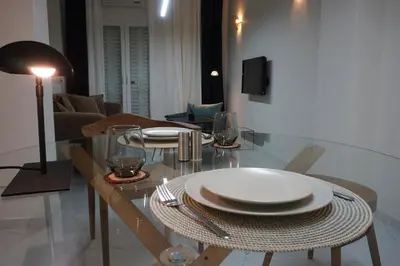 a dining room table with plates and glasses on it at Athens City apartment in Athens