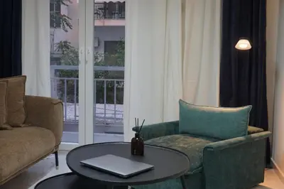 a living room with a couch and a table at Athens City apartment in Athens