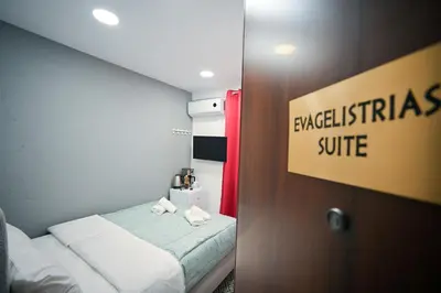 a hotel room with a bed and a sign that reads breakfast suite at Evagelistrias Monastiraki Suite by Zeussuites in Athens