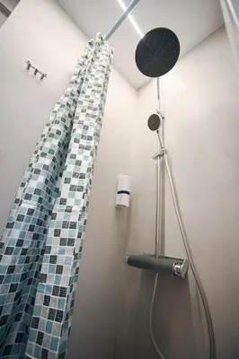 a shower with a glass mosaic shower curtain in a bathroom at Evagelistrias Monastiraki Suite by Zeussuites in Athens