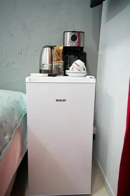 a white refrigerator with a coffee maker on top of it at Evagelistrias Monastiraki Suite by Zeussuites in Athens