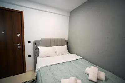 a bedroom with a bed with two towels on it at Evagelistrias Monastiraki Suite by Zeussuites in Athens