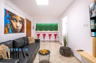 a living room with a black couch and red stools at Athenian Exclusive residence 2&2 ppl in Athens