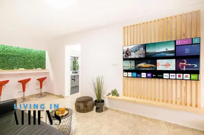 a living room with a large flat screen tv at Athenian Exclusive residence 2&2 ppl in Athens