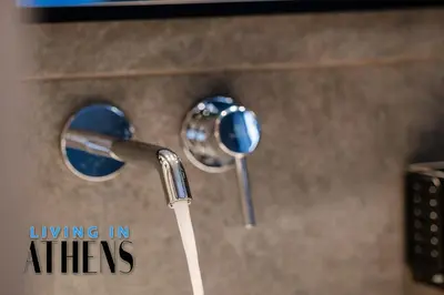 a close up of two faucets in a bathroom at Comfortable & Modern Apt 4floor 3ppl in Piraeus