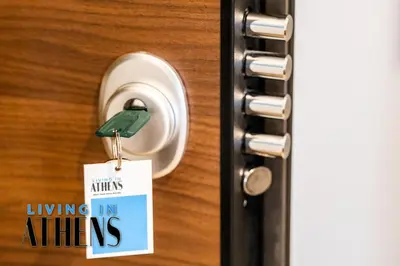 a door knob with a sign hanging on it at Comfortable & Modern Apt 4floor 3ppl in Piraeus