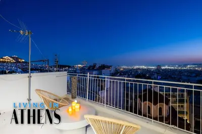 a balcony with a table and chairs and a city at Breathtaking View Studio With Jacuzzi 2ppl 6th flr in Athens