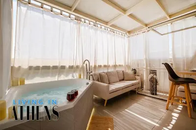 a living room with a tub and a couch at Breathtaking View Studio With Jacuzzi 2ppl 6th flr in Athens