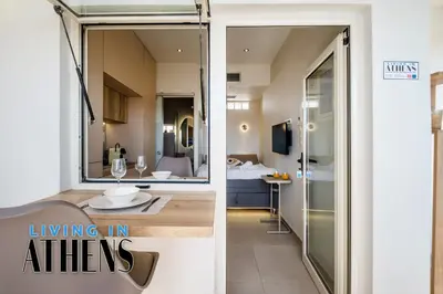 a kitchen and a living room with a glass door at Breathtaking View Studio With Jacuzzi 2ppl 6th flr in Athens
