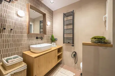 a bathroom with a sink and a mirror at Crown Design Apt - Acropolis in Athens