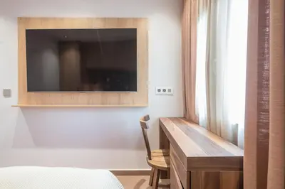 a bedroom with a desk and a tv on a wall at Crown Design Apt - Acropolis in Athens