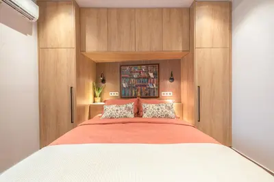 a bedroom with a large bed with wooden cabinets at Crown Design Apt - Acropolis in Athens