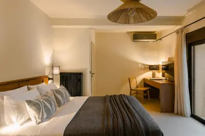 a bedroom with a bed and a desk with a desk at The Attican Villa & Estate in Anavissos