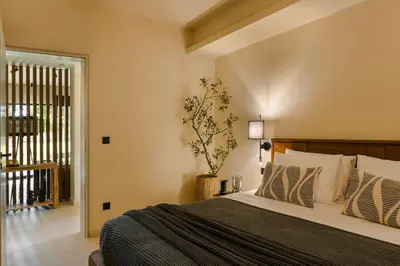 a bedroom with a large bed and a window at The Attican Villa & Estate in Anavissos