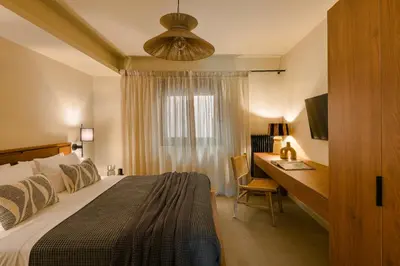 a bedroom with a bed and a desk with a computer at The Attican Villa & Estate in Anavissos