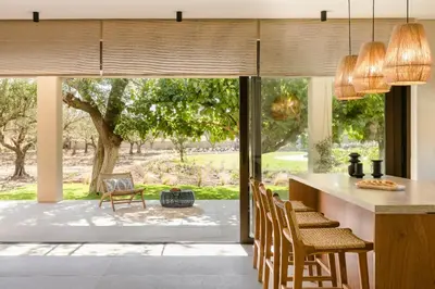 a kitchen with a large glass door leading to a yard at The Attican Villa & Estate in Anavissos