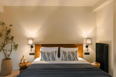 a bedroom with a large bed with two pillows at The Attican Villa & Estate in Anavissos