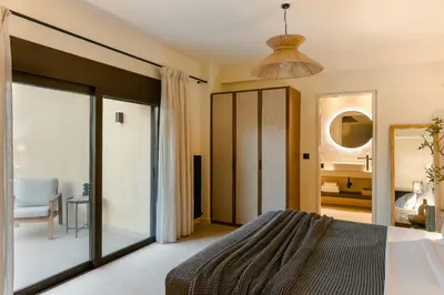 a bedroom with a bed and a sliding glass door at The Attican Villa & Estate in Anavissos