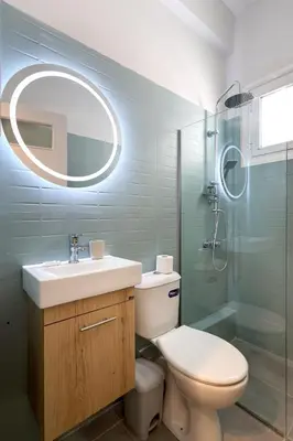 a bathroom with a toilet and a sink and a shower at Muse Studios & Apartments Agia Marina in Agia Marina Aegina