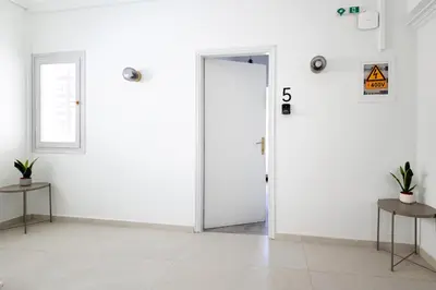 an open door in a room with white walls at Muse Studios & Apartments Agia Marina in Agia Marina Aegina