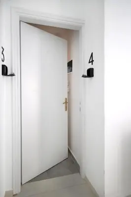 an open door in a room with numbers on the walls at Muse Studios & Apartments Agia Marina in Agia Marina Aegina