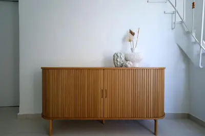 a wooden cabinet in a room with a staircase at Muse Studios & Apartments Escape in Agia Marina Aegina
