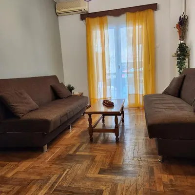 a living room with two couches and a coffee table at Athens Nest two in Athens