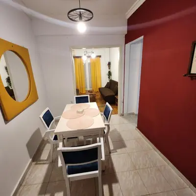 a dining room with a white table and chairs at Athens Nest two in Athens