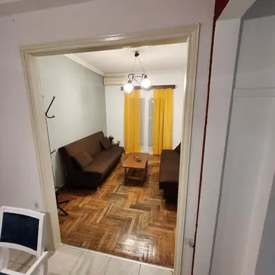a living room with a couch and a table at Athens Nest two in Athens
