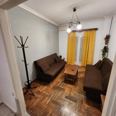 a living room with a couch and a table at Athens Nest two in Athens
