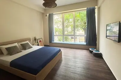 a bedroom with a bed and a large window at Athinas 7 apartment in Athens
