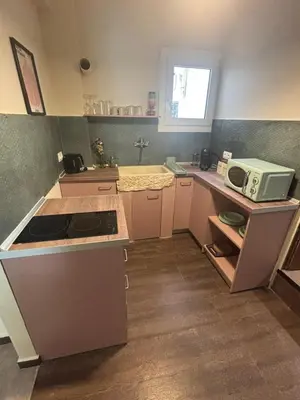 a small kitchen with a microwave and a counter at Athinas 7 apartment in Athens