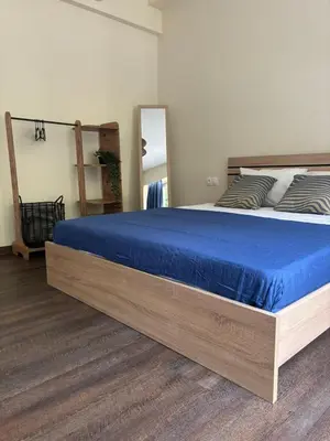 a bedroom with a large bed with a blue blanket at Athinas 7 apartment in Athens