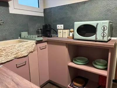 a kitchen with a microwave on top of a counter at Athinas 7 apartment in Athens