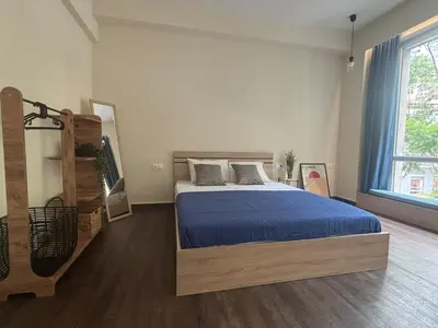 a bedroom with a bed and a large window at Athinas 7 apartment in Athens