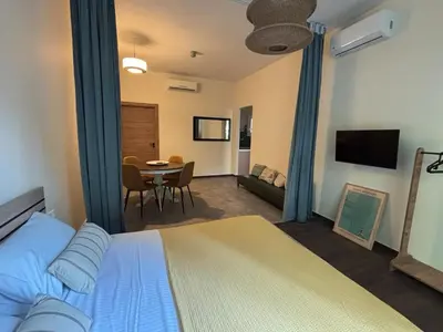 a bedroom with a bed and a dining room at Athinas 7 apartment in Athens