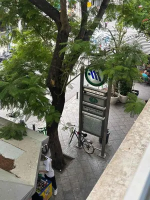 a pepsi sign next to a tree on a sidewalk at Athinas 7 apartment in Athens