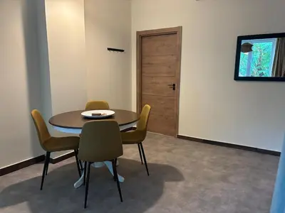 a dining room with a table and chairs and a door at Athinas 7 apartment in Athens