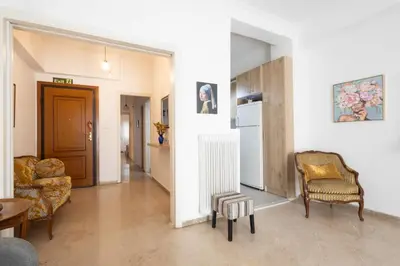 a living room with a couch and a chair at Comfort Apartment with 2 Bedrooms in Athens