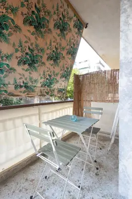 a table and two chairs on a balcony at Comfort Apartment with 2 Bedrooms in Athens